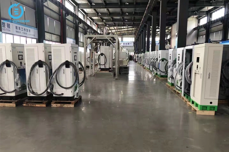 Mass production of DC EV charging stations in a modern manufacturing facility, showcasing multiple units ready for deployment.